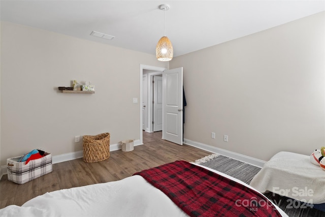 bedroom with hardwood / wood-style flooring