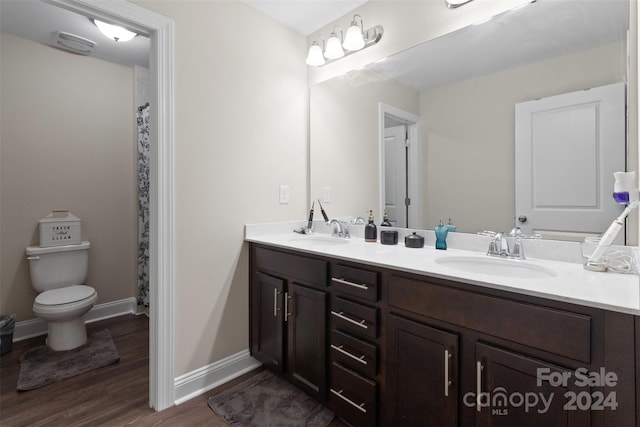 bathroom featuring vanity, hardwood / wood-style flooring, and toilet