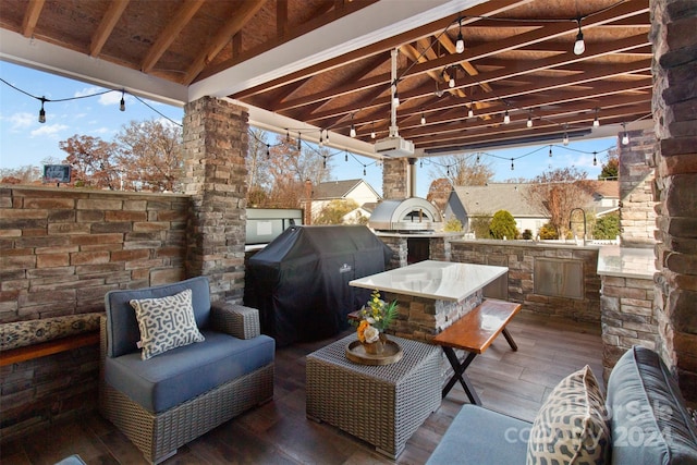 view of patio featuring a grill, area for grilling, and sink