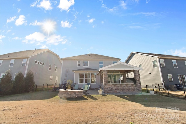 rear view of property with a yard and a patio area