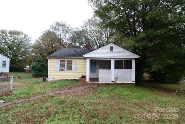 exterior space with a sunroom and a yard