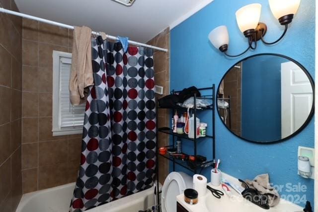 bathroom featuring shower / tub combo and toilet