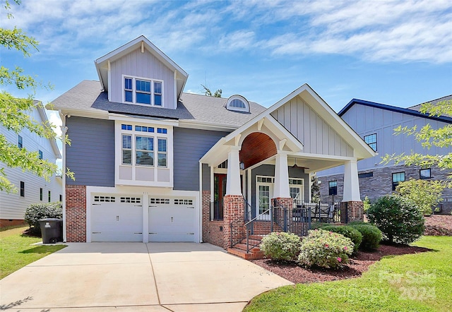 craftsman inspired home featuring covered porch and a garage