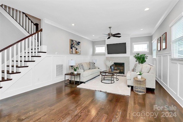 living room featuring plenty of natural light, ceiling fan, and dark wood-type flooring