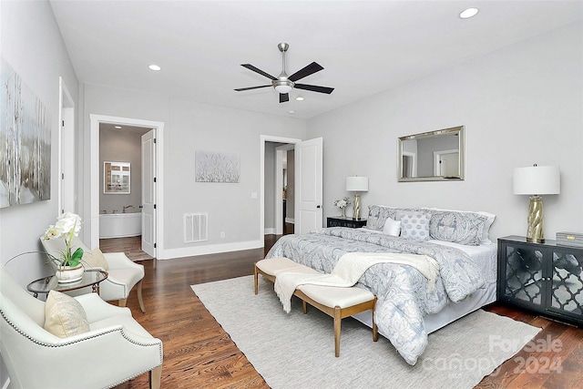 bedroom with connected bathroom, dark hardwood / wood-style floors, and ceiling fan