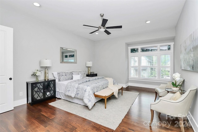 bedroom with ceiling fan and dark hardwood / wood-style floors