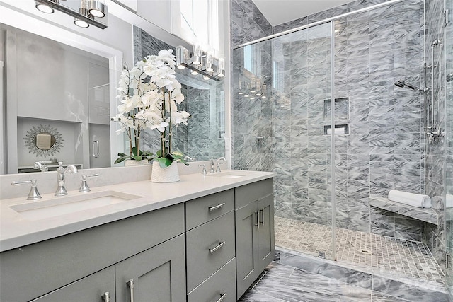 bathroom featuring vanity and a shower with door