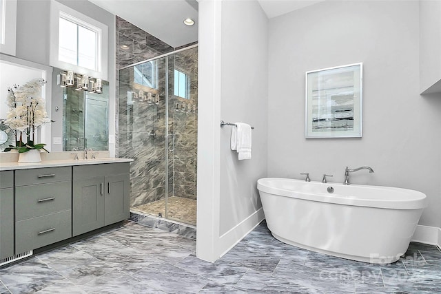 bathroom featuring shower with separate bathtub and vanity