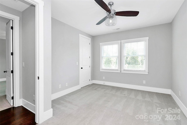 unfurnished bedroom featuring ceiling fan and light colored carpet