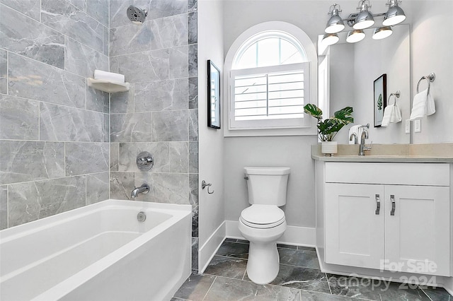 full bathroom featuring vanity, tiled shower / bath combo, and toilet