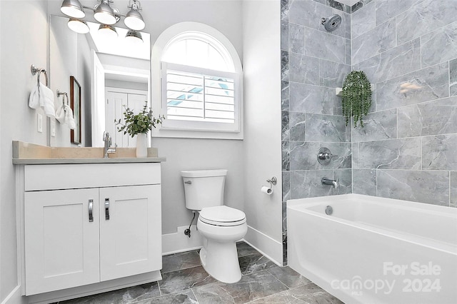 full bathroom featuring vanity, tiled shower / bath combo, and toilet