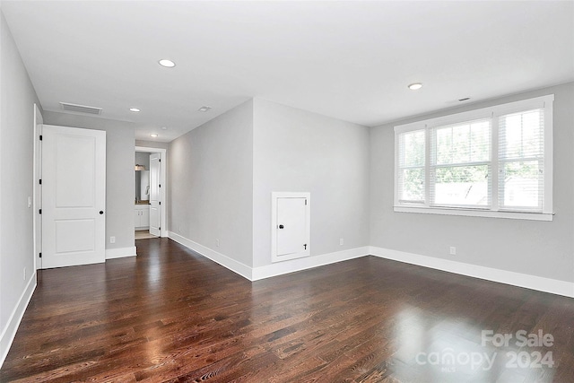 spare room with dark hardwood / wood-style flooring