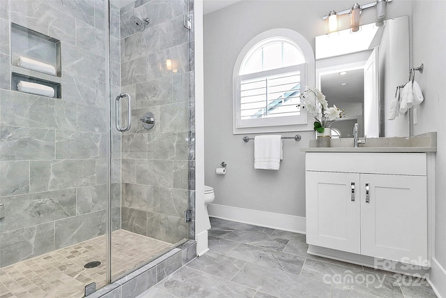 bathroom with vanity, toilet, and an enclosed shower