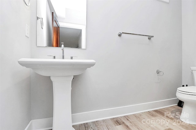 bathroom featuring hardwood / wood-style floors and toilet