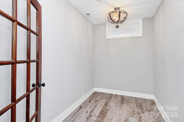 interior space with light hardwood / wood-style floors and a chandelier