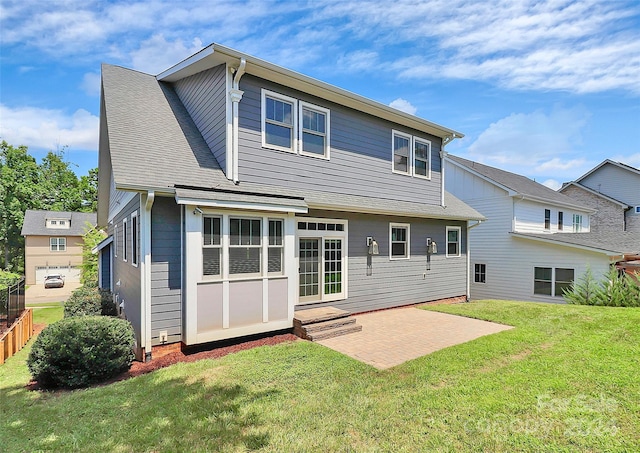 rear view of property featuring a patio area and a yard