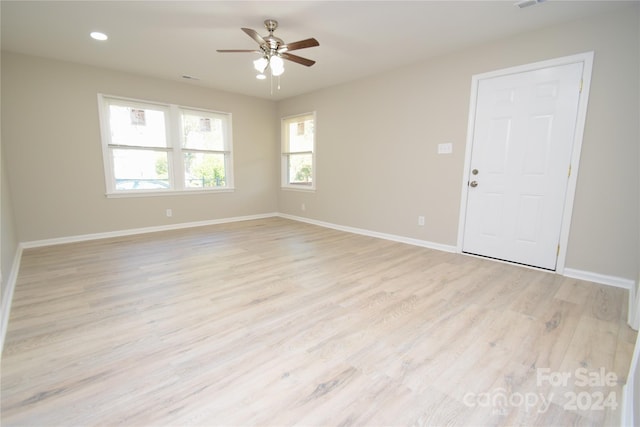 empty room featuring ceiling fan and light wood-type flooring