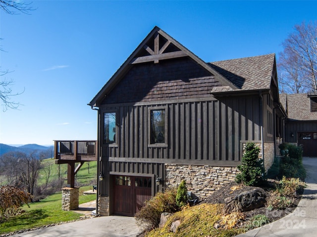 exterior space with a deck with mountain view and a garage