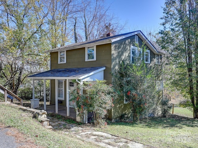 view of front of property with a patio and a front yard