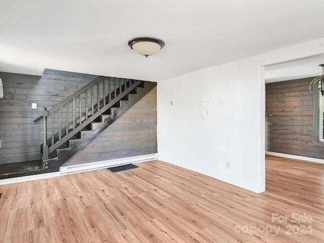 interior space with wood walls and wood-type flooring