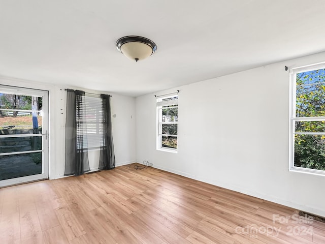 empty room featuring light hardwood / wood-style floors and a healthy amount of sunlight