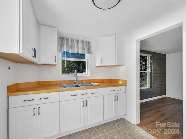 kitchen with sink, white cabinets, and plenty of natural light