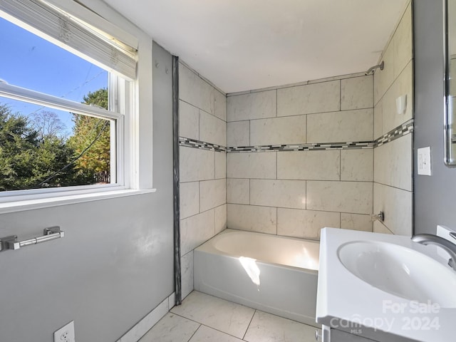 bathroom featuring vanity and tiled shower / bath combo