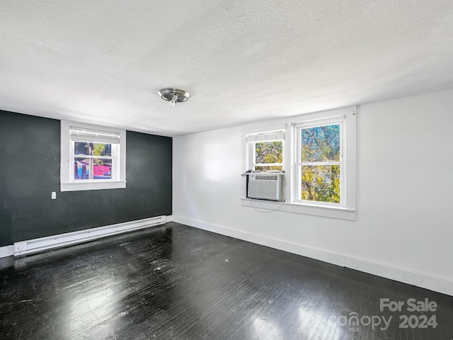 empty room featuring a textured ceiling, cooling unit, a baseboard radiator, and dark hardwood / wood-style floors