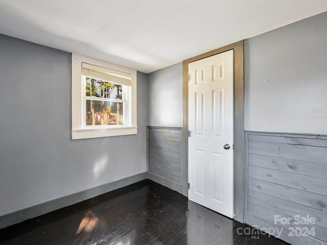 empty room with dark wood-type flooring