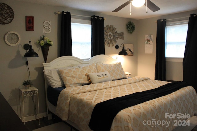 bedroom with multiple windows and ceiling fan