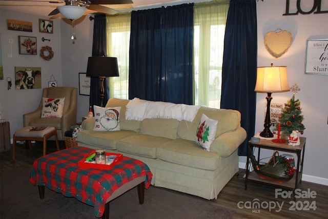 living room featuring dark hardwood / wood-style floors, ceiling fan, and radiator heating unit