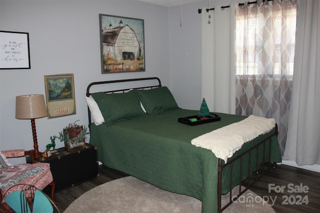 bedroom with dark wood-type flooring