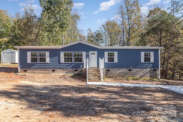 manufactured / mobile home featuring an outbuilding and a garage