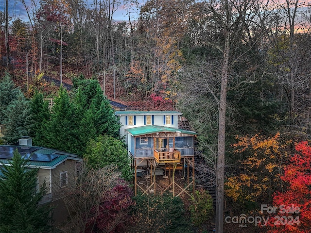 back house at dusk with covered porch