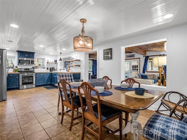 tiled dining room with wooden ceiling and french doors