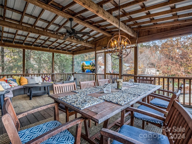 sunroom featuring vaulted ceiling with beams and ceiling fan with notable chandelier