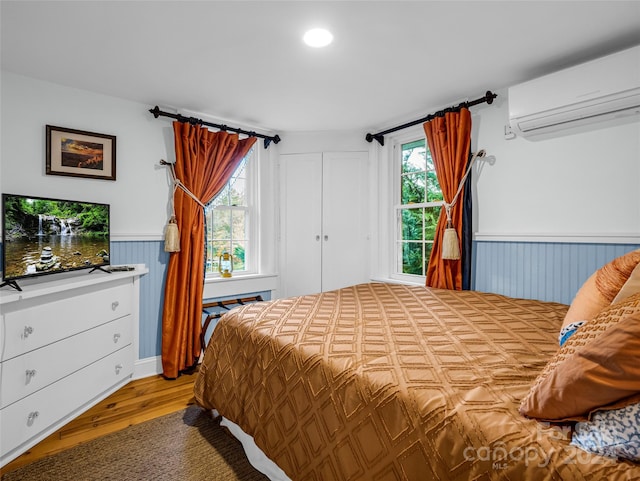 291 Tryon Bay Cir, Lake Lure, NC 28746 - bedroom with a wall mounted air conditioner, wainscoting, wood finished floors, and recessed lighting