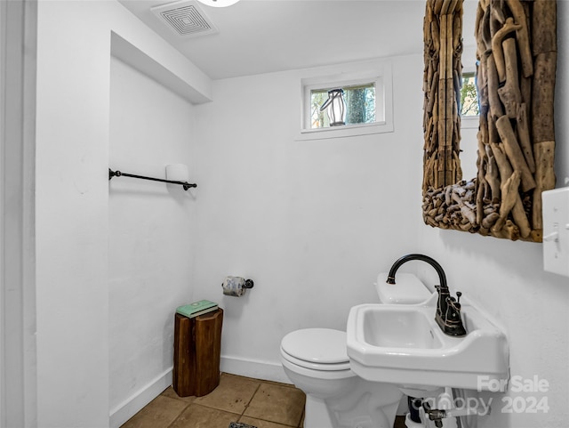 bathroom with tile patterned flooring, toilet, and sink