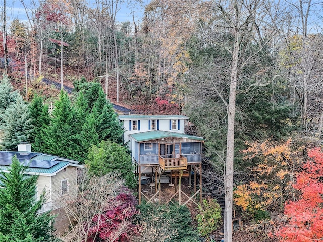 291 Tryon Bay Cir, Lake Lure, NC 28746 - rear view of house with a sunroom, a chimney, a wooded view, and a metal roof