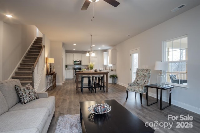 living room with ceiling fan, hardwood / wood-style flooring, and sink