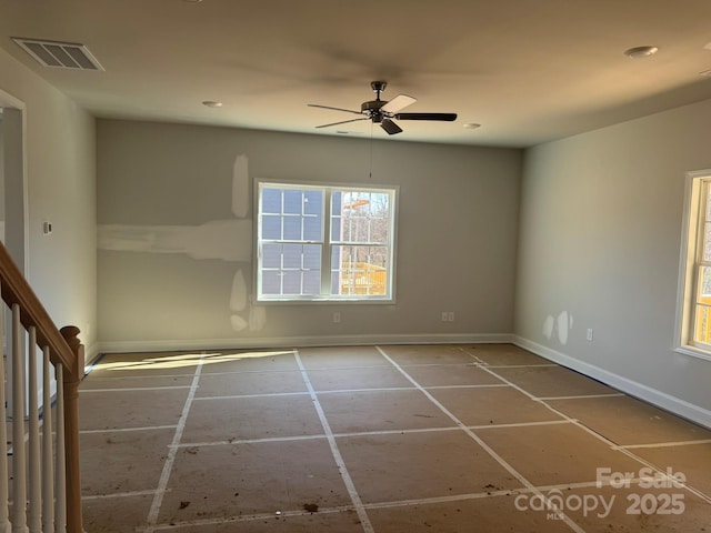 spare room with stairway, baseboards, visible vents, and ceiling fan