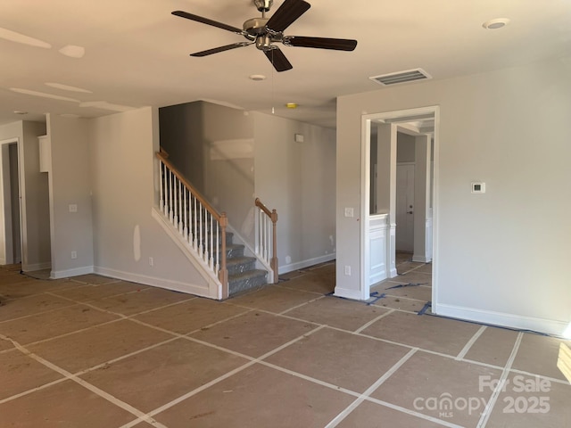 unfurnished room featuring stairs, a ceiling fan, visible vents, and baseboards