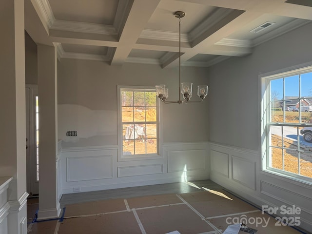 unfurnished dining area with beamed ceiling, coffered ceiling, visible vents, and a healthy amount of sunlight