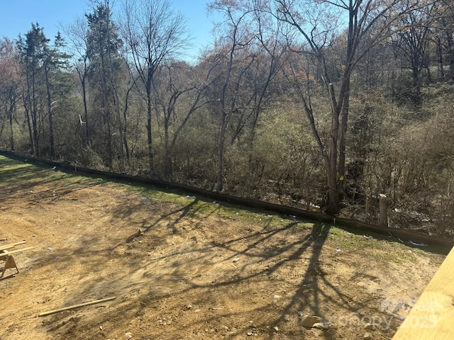 exterior space featuring a forest view