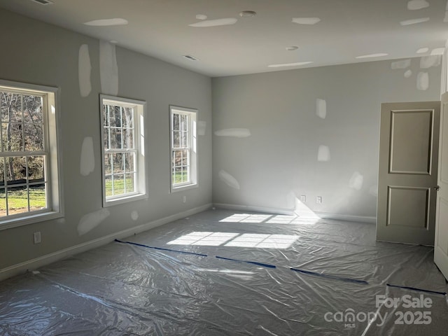 spare room featuring visible vents and baseboards