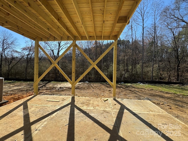 view of yard featuring a patio and a wooded view