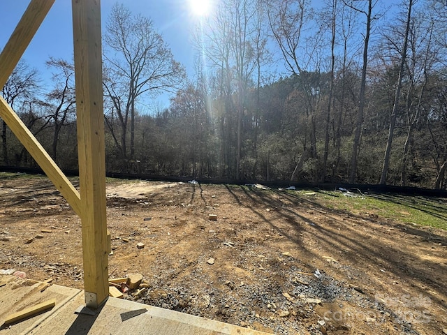 view of yard with a view of trees