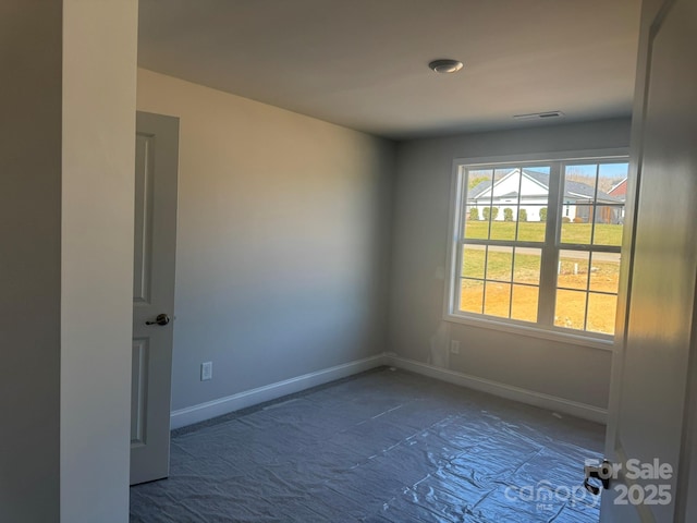 empty room featuring visible vents and baseboards