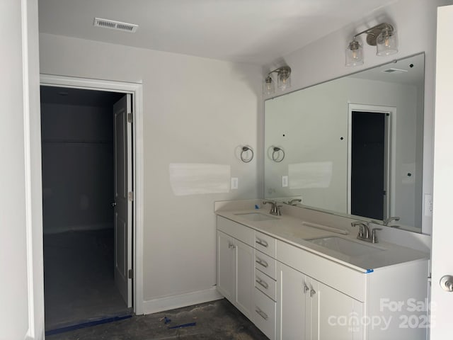 full bathroom with visible vents, a sink, baseboards, and double vanity