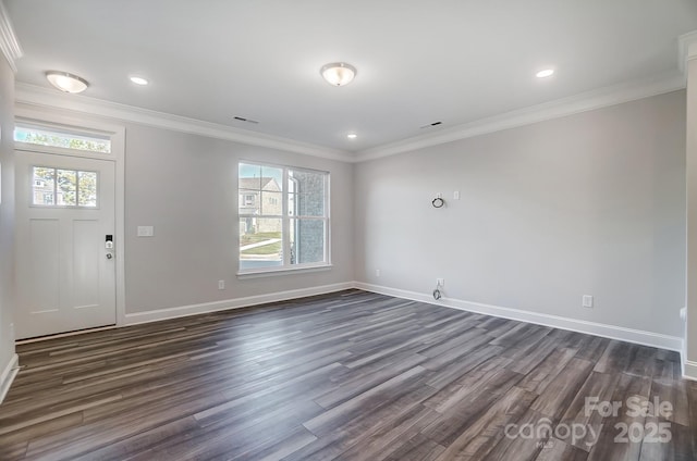 foyer with ornamental molding, dark wood-style flooring, and baseboards